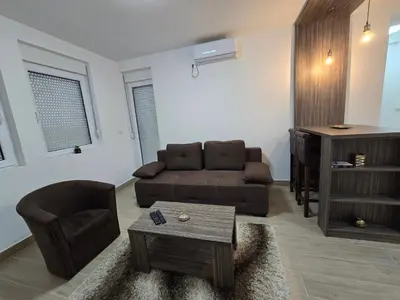 a living room with a couch and a chair at Best apartments 2 in Paraćin