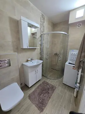a bathroom with a shower and a sink and a toilet at Best apartments 2 in Paraćin