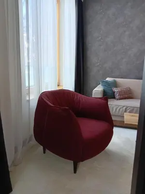 a living room with a red chair and a couch at WOODside 70m2 Kopaonik in Kopaonik