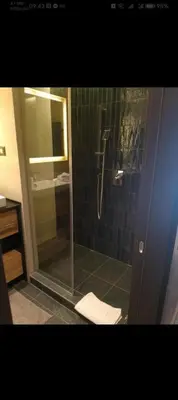 a bathroom with a shower with a glass door at WOODside 70m2 Kopaonik in Kopaonik