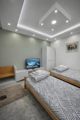 a room with two beds and a flat screen tv at 