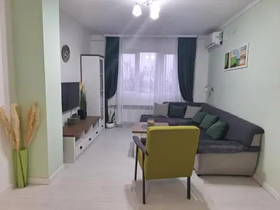 a living room with a couch and a yellow chair at Apartman Nikola Vukosavljevic in Kruševac