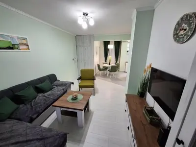 a living room with a couch and a table at Apartman Nikola Vukosavljevic in Kruševac