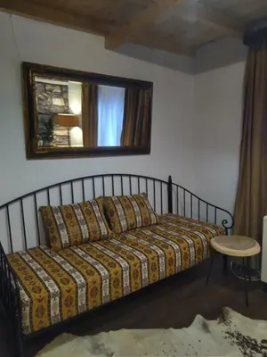 a bedroom with a bed and a mirror on the wall at Rezervat in Jelašnica