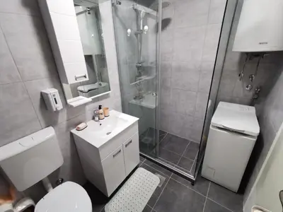 a bathroom with a shower and a toilet and a sink at Lunjica in Niš