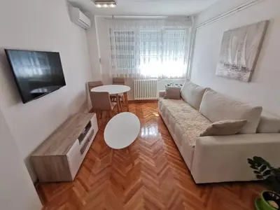 a living room with a couch and a table at Lunjica in Niš