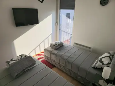a living room with a couch and a flat screen tv at Apartman Nikolić in Soko Banja