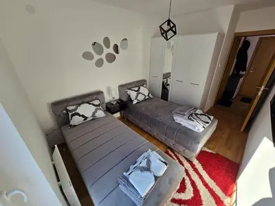 an overhead view of a bedroom with a bed and a couch at Apartman Nikolić in Soko Banja