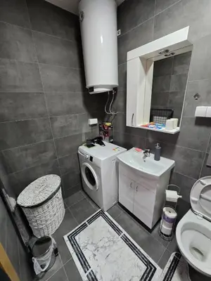 a bathroom with a washing machine and a sink at Apartman Nikolić in Soko Banja