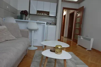 a living room with a couch and two tables at Stan u centru Niša, Obilićev venac in Niš