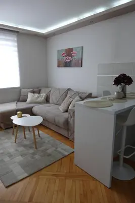a living room with a couch and a table at Stan u centru Niša, Obilićev venac in Niš