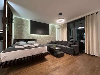 a bedroom with a bed and a couch at LiboroPlanet in Niš