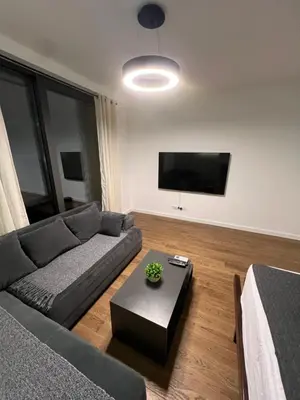 a living room with a couch and a table at LiboroPlanet in Niš