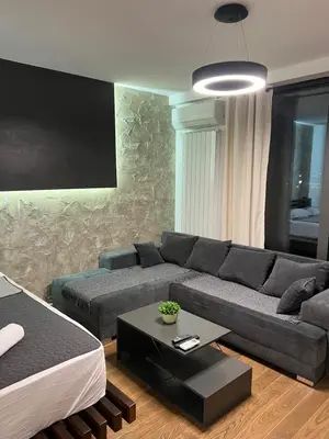 a living room with a couch and a table at LiboroPlanet in Niš