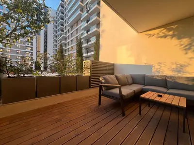 a couch sitting on a wooden deck with a table at LiboroPlanet in Niš