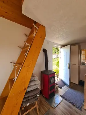 a staircase in a room with a wood stove at Goč Sunčani breg in Stanišinci