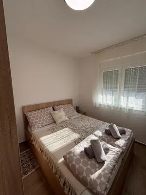 a bedroom with a bed with two pillows on it at Jasmina apartman in Soko Banja