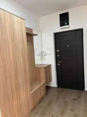 a room with a wooden closet and a black door at Jasmina apartman in Soko Banja