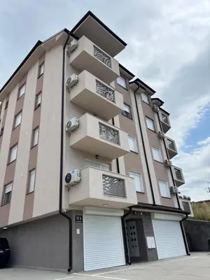 a tall building with two garagelled at Jasmina apartman in Soko Banja