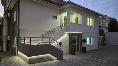 a house with a staircase on the side of it at California Apartments in Niš
