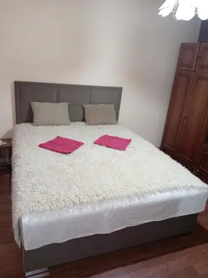 a bedroom with a bed with pink towels on it at Seoska idila in Bela Palanka