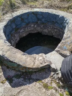 a stone pit with a pool of water in it at Seoska idila in Bela Palanka
