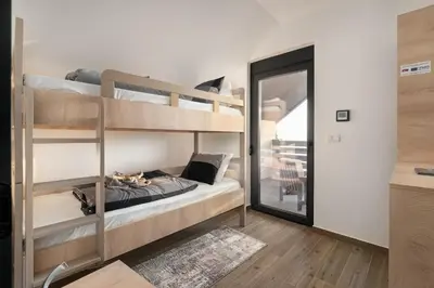 a room with two bunk beds and a mirror at Vision apartmani Goč in Goč