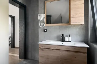 a bathroom with a white sink and a mirror at Vision apartmani Goč in Goč