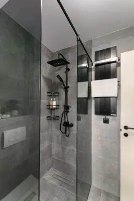 a shower with a glass door in a bathroom at Vision apartmani Goč in Goč
