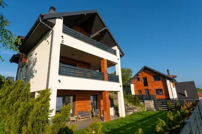 a house on top of a hill with a building at Vision apartmani Goč in Goč
