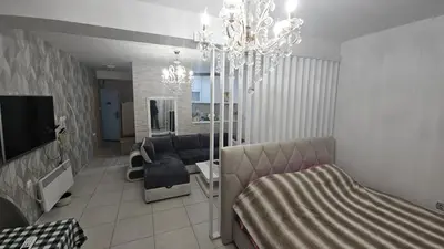 a living room with a couch and a chandelier at Kristal in Niš