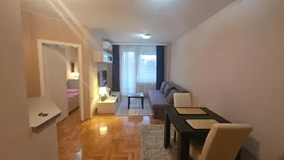 a living room with a couch and a table at Riverside rest in Niš