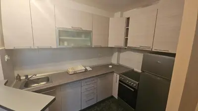 a kitchen with a sink and a black refrigerator at Riverside rest in Niš
