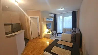 a small living room with a couch and a window at Riverside rest in Niš