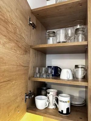 a kitchen with wooden shelves with pots and pans at Konaci Kopaonik 28 in Kopaonik