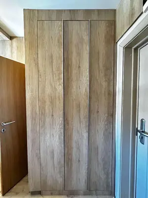 a large wooden cabinet in a room with a door at Konaci Kopaonik 28 in Kopaonik