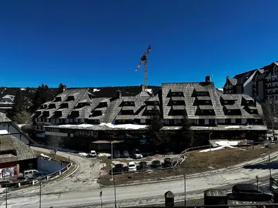 a large building with a flag on top of it at Konaci Kopaonik 28 in Kopaonik