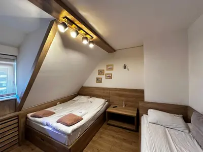 a room with two beds in a room at Konaci Kopaonik 28 in Kopaonik