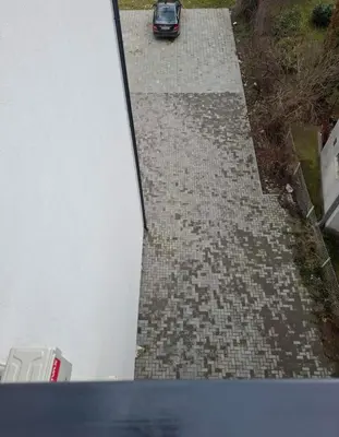 a car parked on a driveway with a house at Apartman STAR Vrnjačka Banja in Vrnjci