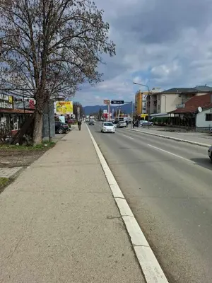 a city street with cars driving down the road at Apartman STAR Vrnjačka Banja in Vrnjci