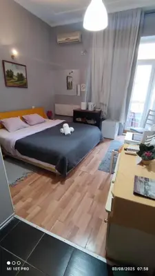 a bedroom with a large bed and a desk at Top rooms in Niš