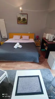 a bedroom with a bed with two towels on it at Top rooms in Niš
