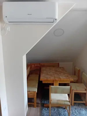 a room with tables and chairs and a ceiling fan at Apartman Anči in Vrnjačka Banja