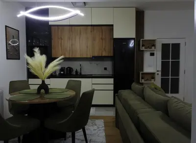 a living room with a couch and a table at Apartman Biser Vranja - FREE PARKING - CITY CENTER in Vranje