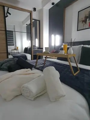 a bedroom with a bed with towels on it at Apartman Biser Vranja - FREE PARKING - CITY CENTER in Vranje