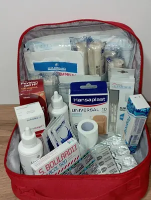 a red suitcase filled with toiletries and other items at Apartman Biser Vranja - FREE PARKING - CITY CENTER in Vranje