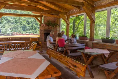 a group of people sitting at a table in a restaurant at Spa & wellness Villa Garetov Konak in Prolomska Banja
