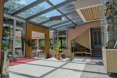 a conservatory with a glass ceiling and a patio at Spa & wellness Villa Garetov Konak in Prolomska Banja