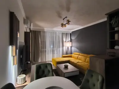 a living room with a yellow couch and chairs at Mina Lux in Paraćin