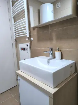 a bathroom with a white sink in a room at Mina Lux in Paraćin